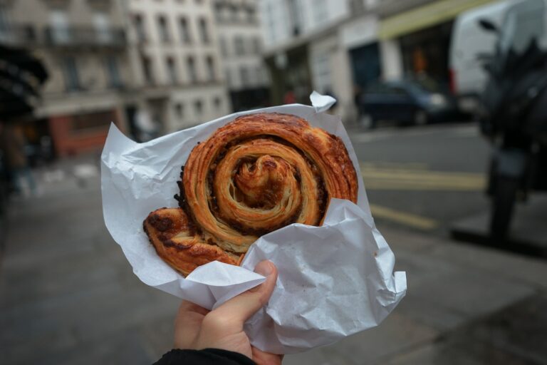 person holding brown bread on white paper