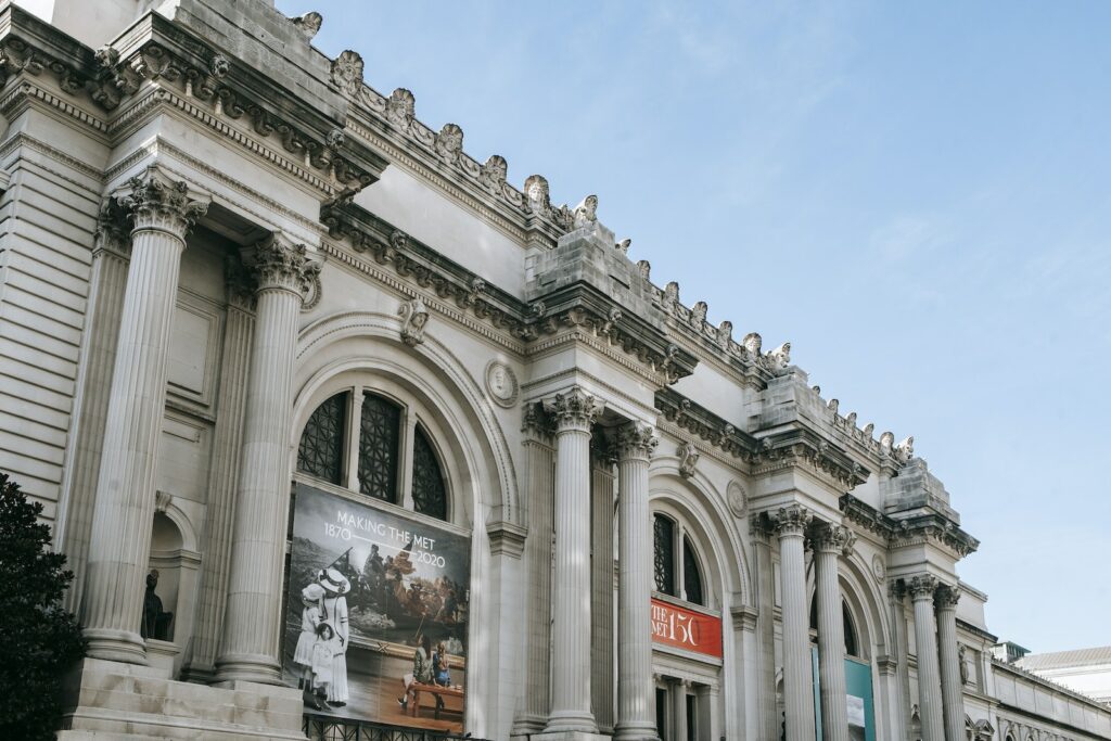 Facade of famous art museum with columns and sculptures