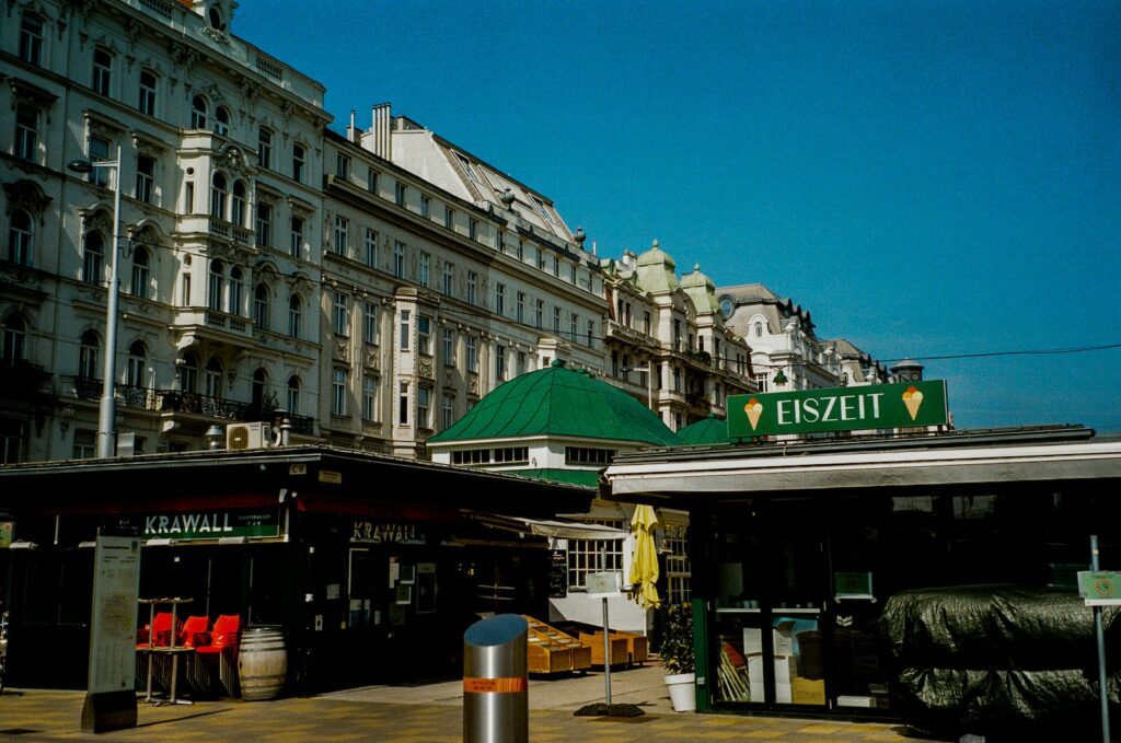 a building with a green roof next to a street