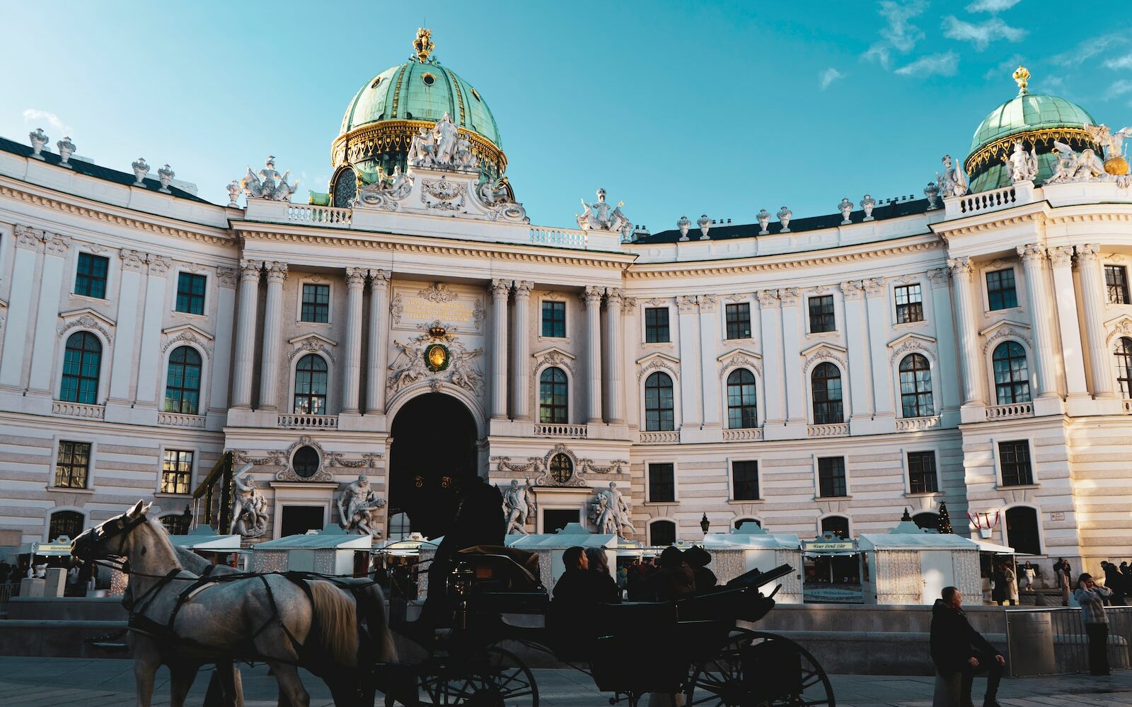 a horse drawn carriage in front of a large building